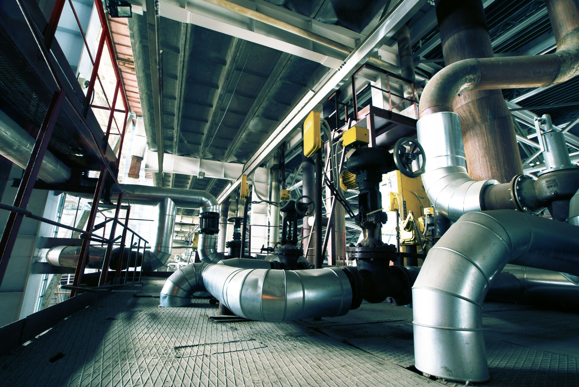 Coldcase refrigeration plant room with large insulated pipework and machinery