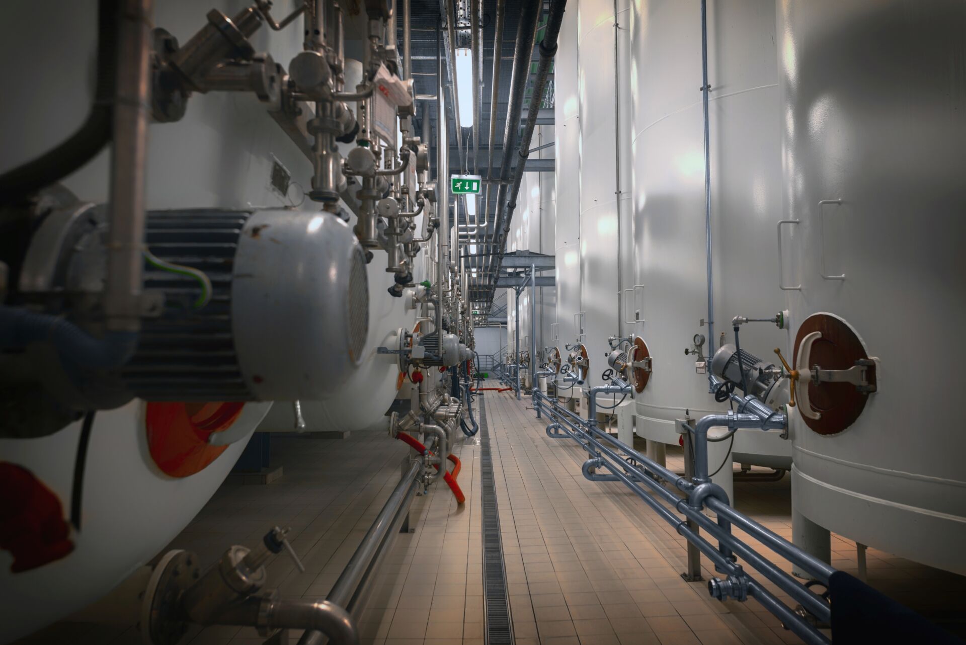 Coldcase factory process area with large storage vessels and refrigeration pipework