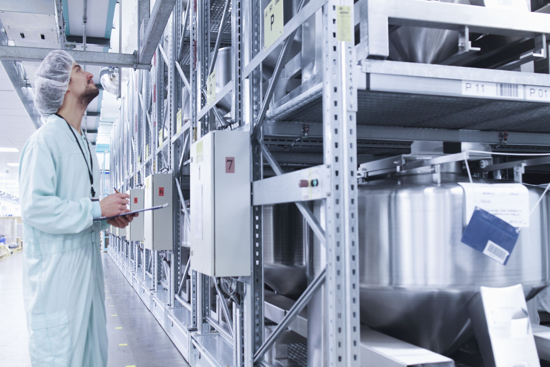 Coldcase technician inspecting equipment in a temperature controlled industrial storage area